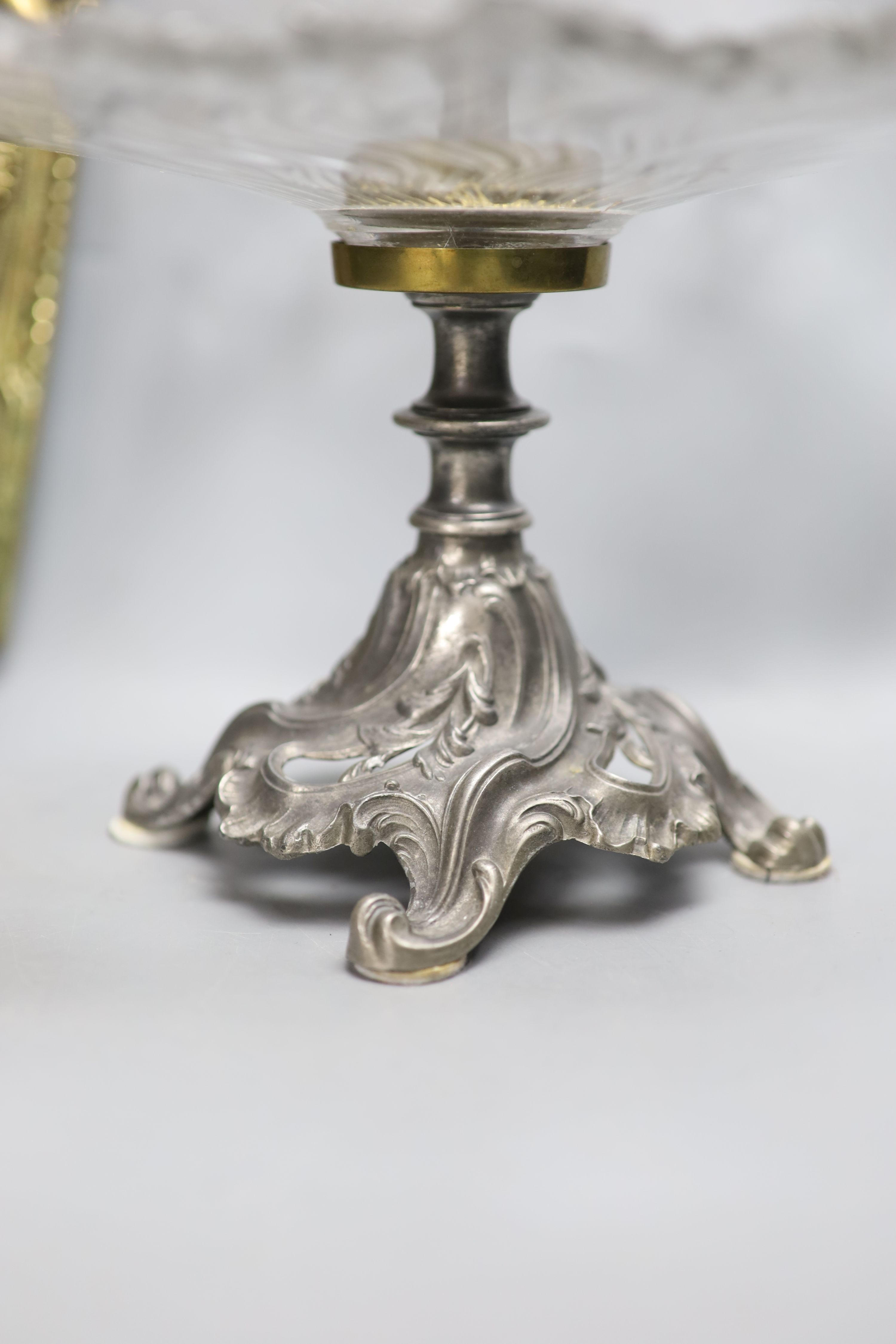 A moulded glass cake stand, on a cast metal base, diameter 31cm, and a cast brass wall sconce